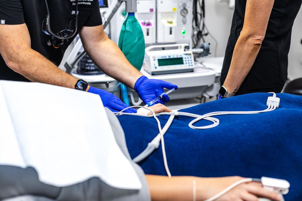 Dentist monitoring a patient during IV sedation