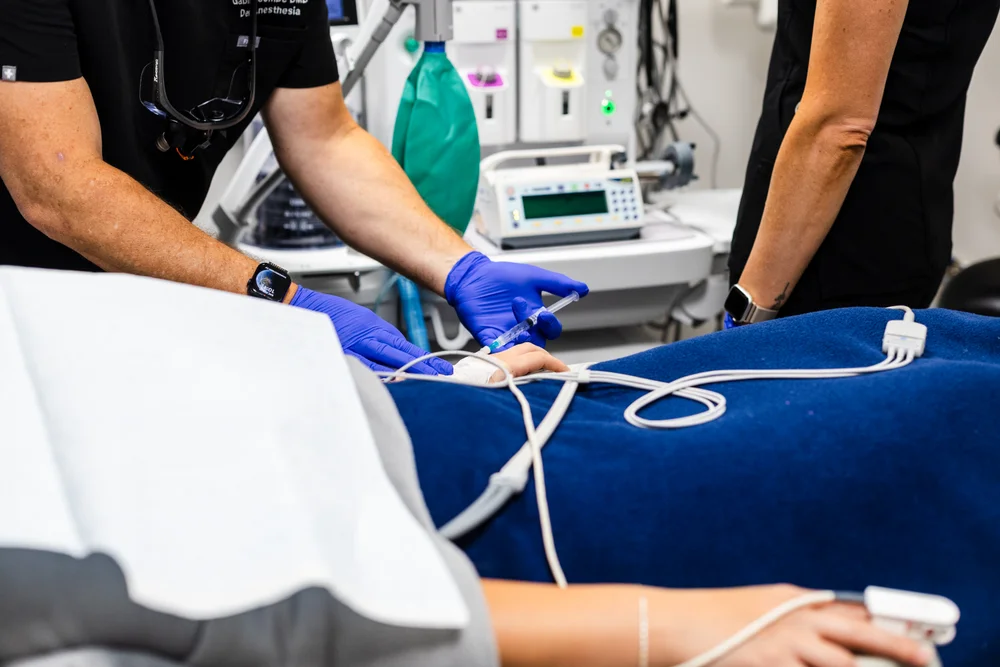 A doctor administering general anasthesia to a patient.