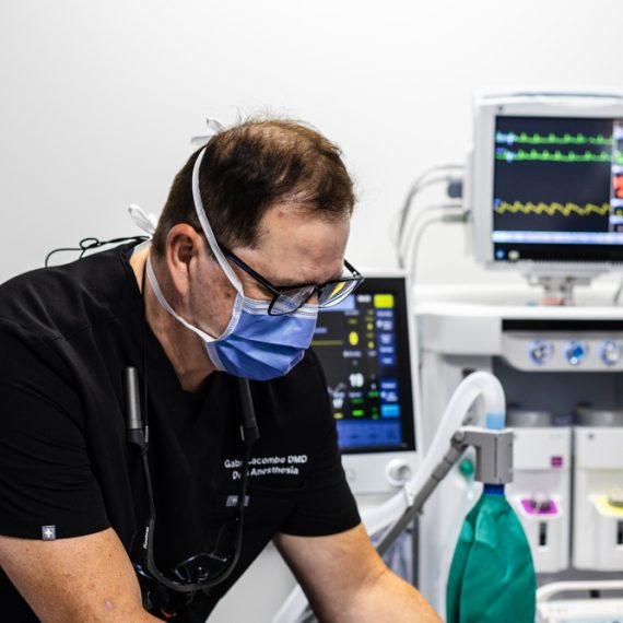 A doctor administering general anasthesia to a patient.